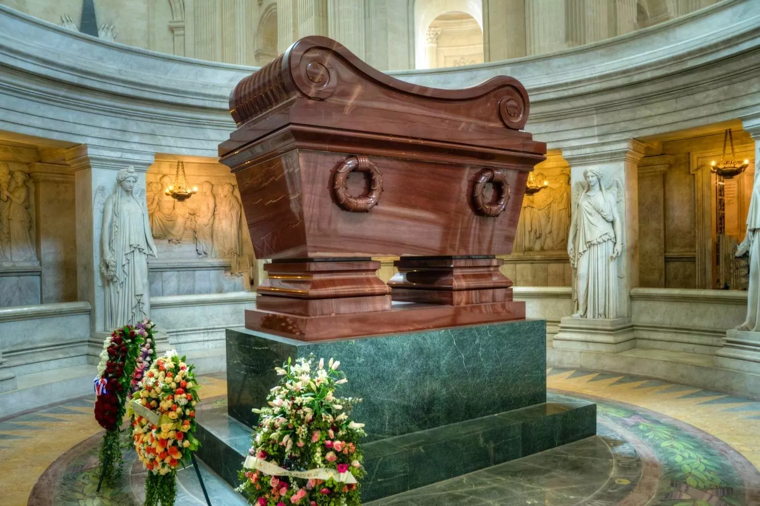 Napoleon's tomb under the dome of Les Invalides, surrounded by wreaths of flowers